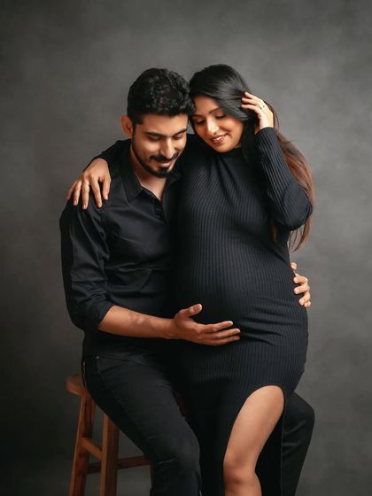 An intimate seated pose that feels both modern and timeless. The all-black attire creates a sleek and sophisticated look for this maternity session.