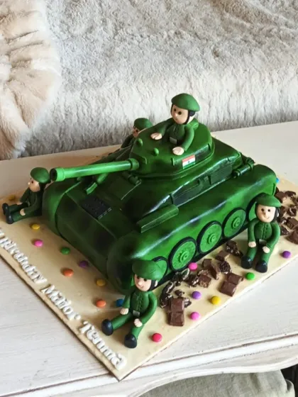 An impressive 3D sculpted army tank cake, complete with soldier figures, perfect for an action-packed birthday celebration.