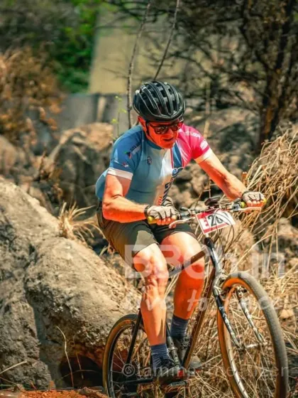 It's not just about speed, it's about skill. A rider expertly navigates a challenging rock garden section during one of our MTB XCO races, demonstrating the technical terrain we offer.