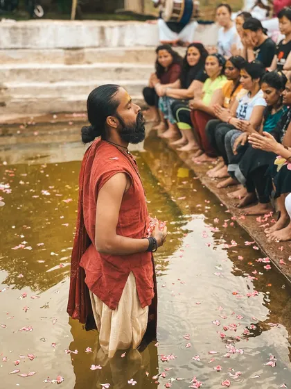 I stand in the river, leading a water ceremony with students gathered on the steps. Connecting with the elements is a powerful way to understand the flow of life and energy.