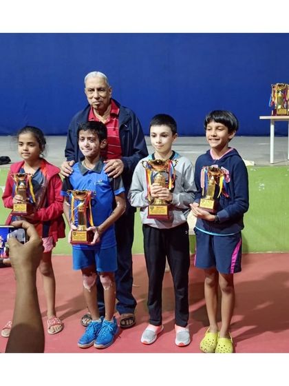 A group of our youngest champions posing with their trophies after a successful tournament. The future of our academy is bright with such dedicated and talented players.