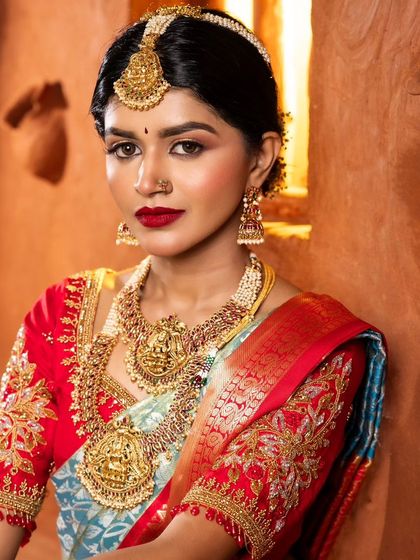 A stunning close-up of the bride. This shot highlights the precision of the eye makeup, the flawless skin, and the beautiful red lip, all key elements of my bridal signature style.