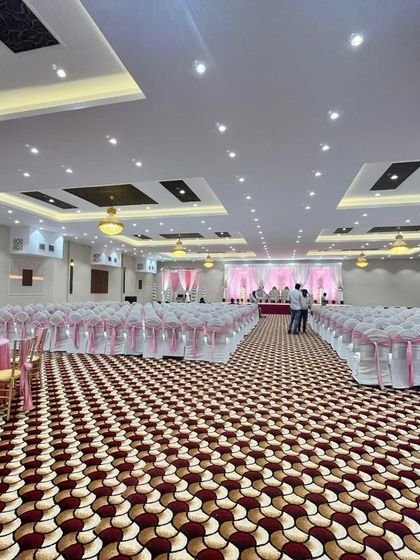 Another angle of the Royal Garden banquet in Panvel, set up with pink-themed chair covers. The sheer size of the hall is evident, making it ideal for the biggest celebrations.