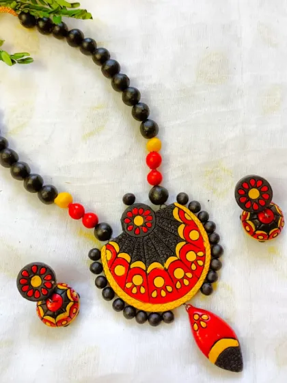 A bold red, yellow, and black version of the fan-shaped pendant necklace.
