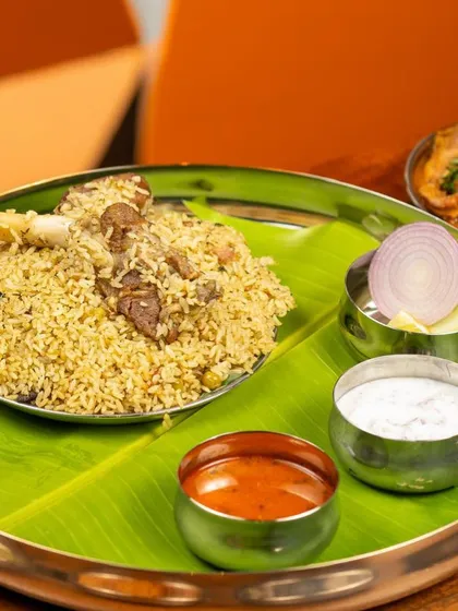 A full meal experience featuring my Bannur Mutton Palav. Served on a traditional banana leaf with onion raita and salan, this showcases the complete, flavourful meal as it's meant to be enjoyed.