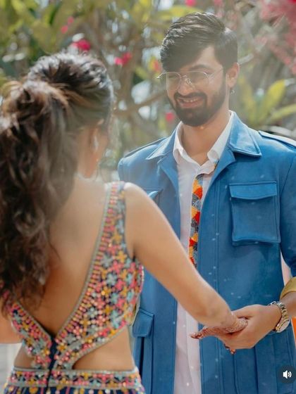 A shot from the back showing the bride's textured, wavy ponytail. It's a youthful and modern hairstyle for a pre wedding celebration.