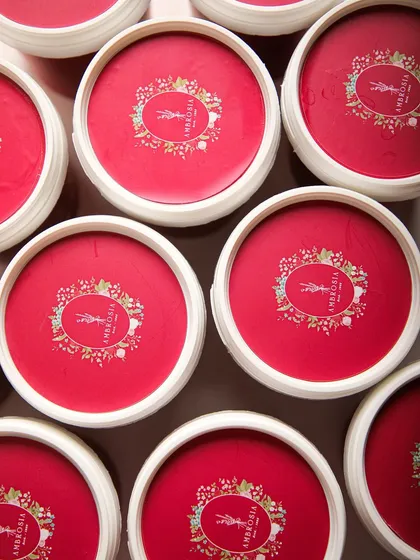 An overhead shot of our signature red ice cream tubs, ready to be filled with freshly churned goodness. A promise of quality in every package.