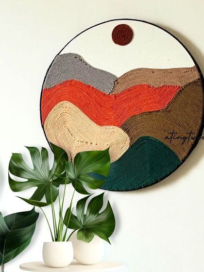 This stunning circular wall hanging is a masterpiece of textured artistry. The vibrant, earthy colors and intricate details create a unique piece that will elevate any space.
