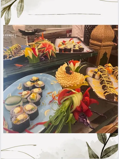 Another view of our sushi counter, featuring rolls garnished with carved vegetables, demonstrating our flair for food art.