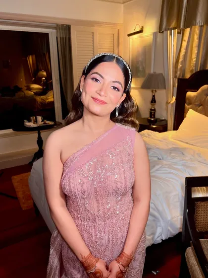 A sweet, candid moment showing off the rosy glow of her sangeet makeup. The look is soft, romantic, and perfect for a night of celebration.