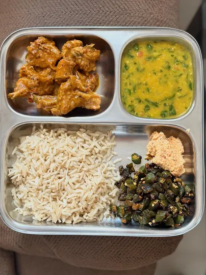 A repeat of my meal with brown rice, chicken curry, dal, and sautéed okra.