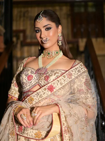 A modern take on royalty. The bride's open hair and smoky eyes give a contemporary edge to this otherwise traditional and elegant ivory look.