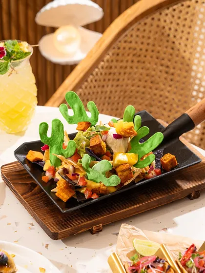 Fun and creative "Barcelona Nachos" with cactus-shaped tortilla chips. This highlights the restaurant's playful personality.