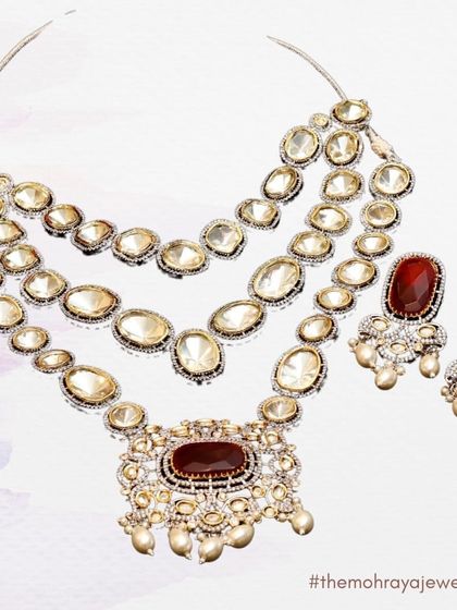 An illustration of a beautiful three-layered polki necklace with a large ruby centerpiece. A classic and elegant choice.