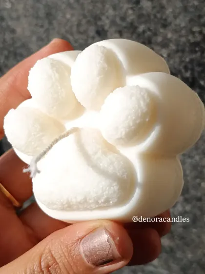Another close-up of the paw candle, held in hand.