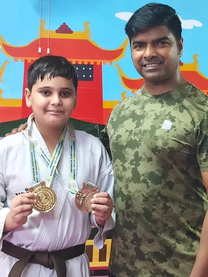 A double win. This student proudly displays his gold and bronze medals after a successful performance at the national level.