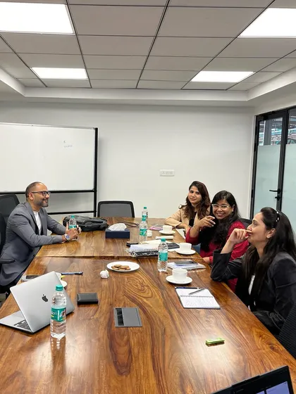 A candid moment of discussion during a professional development workshop. Creating a relaxed atmosphere encourages open dialogue and peer to peer learning among professionals.