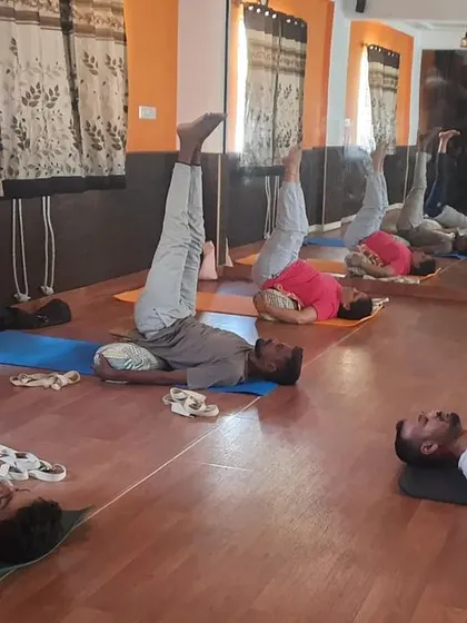 For deep relaxation, I guide my students through Restorative Yin Yoga. In this session, we are using bolsters for support in Viparita Karani (Legs-Up-the-Wall Pose), a gentle inversion that calms the nervous system, reduces stress, and improves circulation.