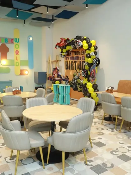 The dining area set up for a racing-themed party. The backdrop and balloon arch create a fantastic photo opportunity and central point for the celebration.