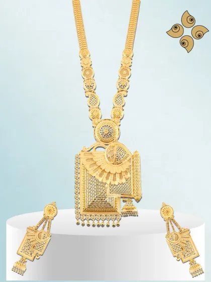 A statement long necklace set with a large, square pendant and intricate gold work. I design these heavy pieces to be the centerpiece of a bridal collection.