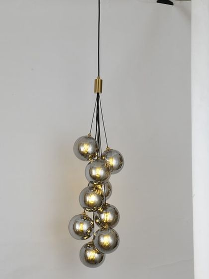 A cluster of smoked glass globes hanging like a bunch of grapes. This is a stylish choice for a corner or a small entryway.