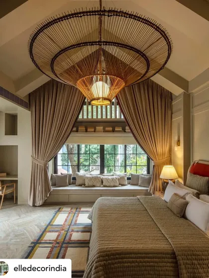The master suite of Summer Haus, a Mumbai bungalow we designed for a filmmaker couple. The design features a dramatic bay window and a custom bamboo chandelier, reflecting a blend of diverse cultures and a love for cinematic, memorable spaces.