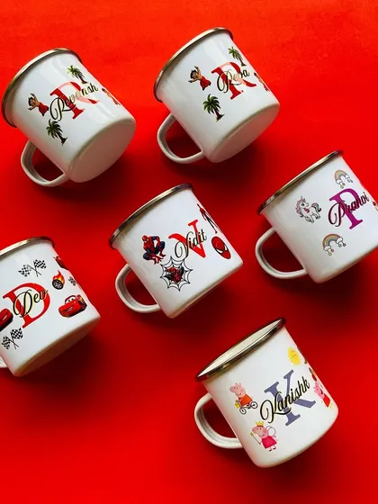 An array of our personalised kids' mugs against a vibrant red background. Each mug is customised with a name, initial, and a fun character theme.