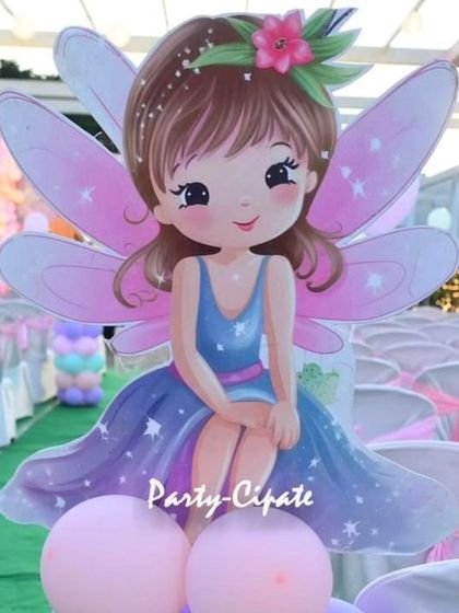 I use props of all sizes to build a layered look. This life-sized fairy cutout on a balloon base was a great way to greet guests and add a touch of magic to the seating area.