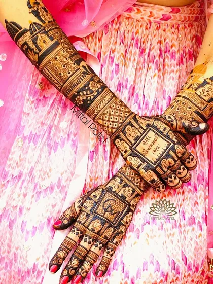 The back of a bridal design, featuring a grid of auspicious symbols and a "kanyadaan" scene.