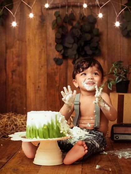 Look at that happy expression. This little one loved his cake during this rustic, barn-themed first birthday photoshoot.