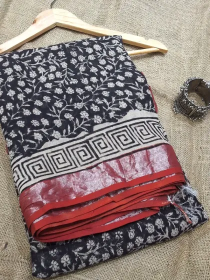 A classic black and red combination in our cotton linen handblock printed saree collection. The traditional motifs and the striking contrast make it a timeless piece.