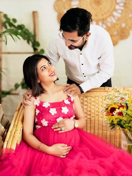 A close-up, intimate moment between an expecting couple, filled with love and gentle smiles.