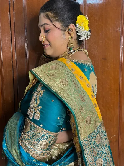 A beautiful shot showing the back of the blouse and the elegant bridal bun, a key part of the Maharashtrian look.