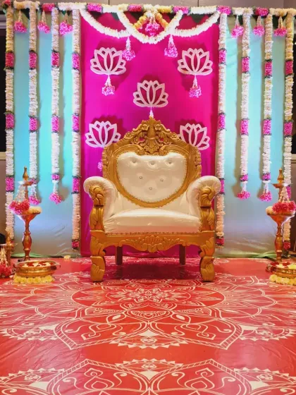 Another angle of the pink lotus-themed Seemantham decor, highlighting the traditional lamps and floral arrangements.