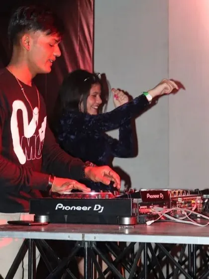 A fun moment teaching someone the basics on the decks during a live set. It's all about sharing the love for music.