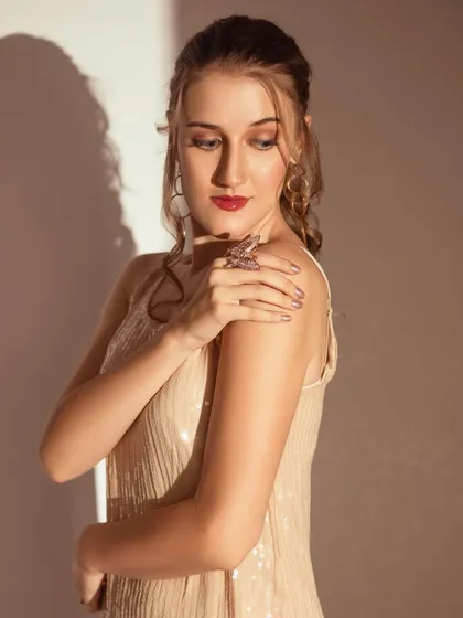 Playing with hard light and shadows to create a dramatic effect. This technique adds an artistic, moody feel to a fashion portrait.
