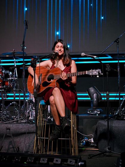 A smiling shot from the stage, surrounded by my band's instruments. This is my happy place.