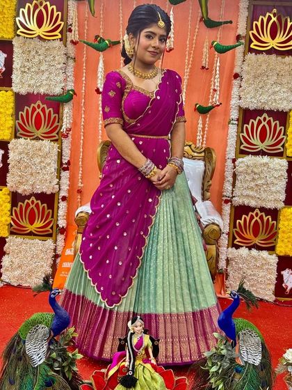Nothing makes me happier than dressing sisters for their special moments. I designed these matching turquoise and purple Langa Voni outfits for a half saree function, ensuring they both looked coordinated yet unique.