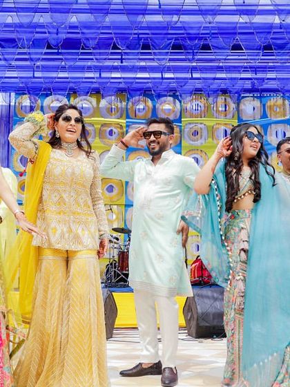The bride's family making the mehendi event brighter with their smiles and coordinated dance moves.