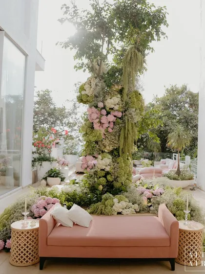 For the outdoor area, we created a beautiful floral installation around an existing tree, blending our design seamlessly with the natural surroundings. The pastel pink and green hues created a romantic and tranquil atmosphere.