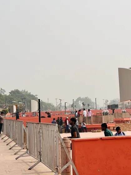 This image provides a behind-the-scenes look at the daytime setup for the Ayodhya event. It reveals the scale of the installation, with numerous speaker posts and control stations being prepared along the ghats hours before the festivities began.