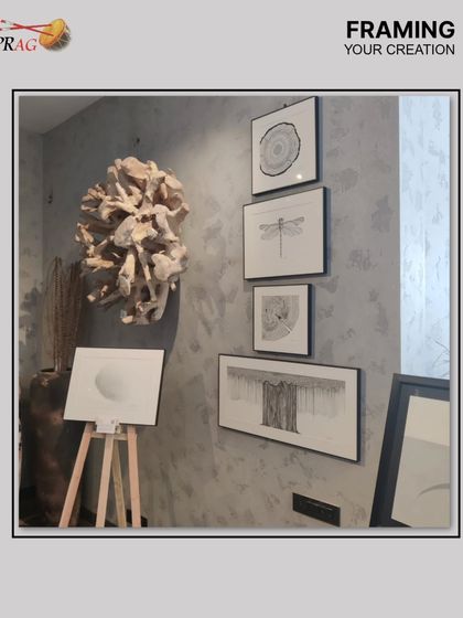 A beautifully curated gallery wall featuring a series of delicate black and white drawings. We worked with the client to determine the optimal arrangement, creating a dynamic and artistic composition on a textured wall.