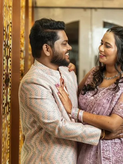 A happy, interactive portrait of the couple, capturing their smiles and the intricate details of their engagement outfits.