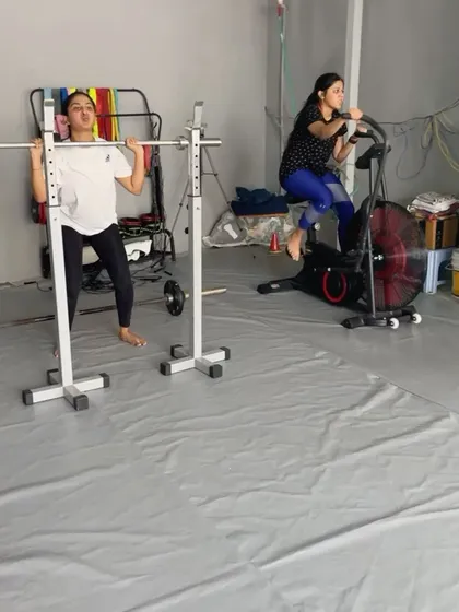 A snapshot from a busy class, with members working on barbell squats and hitting the air bike for a serious cardio blast.