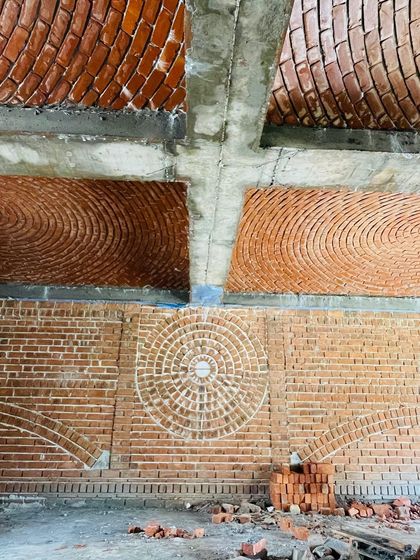 Another angle of the yoga room's brickwork, highlighting the different textures and patterns. Building with brick in this way is like painting with masonry, creating a unique and artistic environment.
