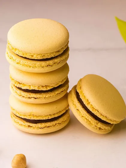 A stack of our light yellow macarons, likely a lemon or vanilla flavour. Each one is a small bite of happiness.