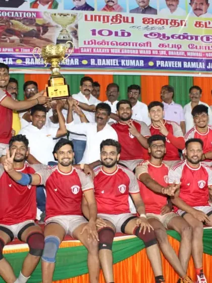 The team celebrating on stage after being crowned champions at the Maharashtra Tamil Sports tournament.