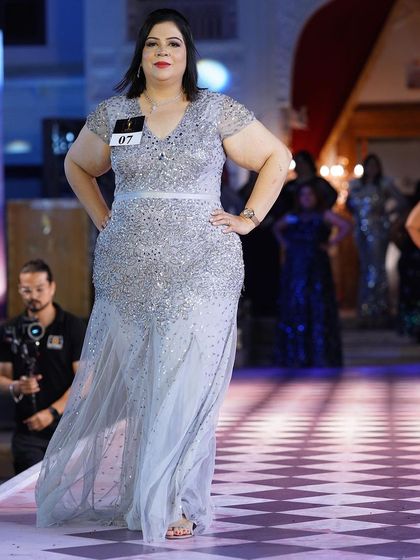 A silver sequined plus-size gown with cap sleeves. It’s a classic, elegant choice that will never go out of style.