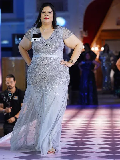 A silver sequined plus-size gown with cap sleeves. It’s a classic, elegant choice that will never go out of style.