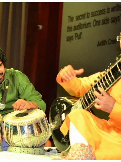 Engaging in a musical dialogue with the tabla player during a performance for students in Gurgaon. This helps them understand the concept of 'Jugalbandi'.